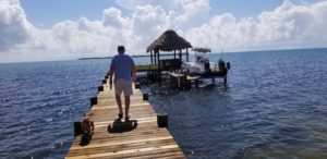 Michael Kramer owner of Singing Sands, walks to pier - Belize_offshore_company_Belize_offshore_account